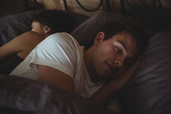 Soft morning light in a minimalist bedroom with linen bedding