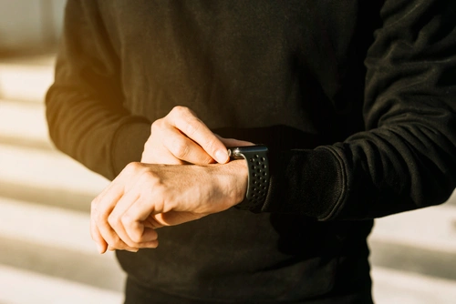 Close-up of the Meridia One band on a wrist over a white linen sleeve